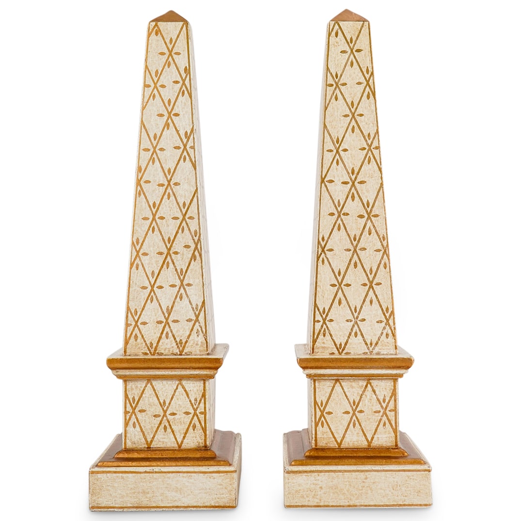 Pair Of Decorative Gilt Accented Composite Obelisks: DESCRIPTION: Two matching obelisks crafted from composite material decorated with gilt geometric patterns and accenting. CIRCA: 20th Century ORIGIN: Continental DIMENSIONS: H: 17.75" W: 5" L: 5" CONDI