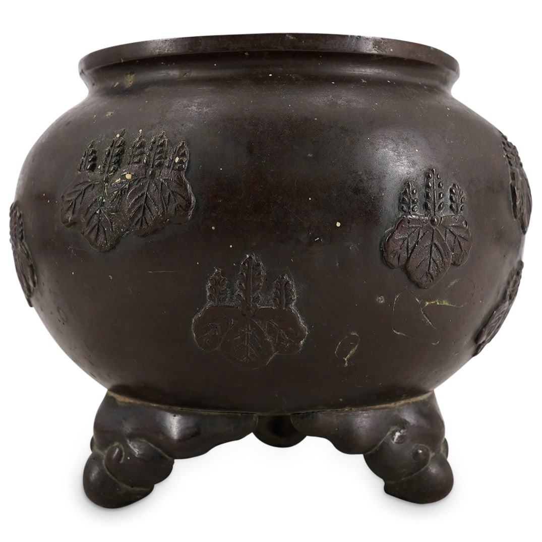 Antique Japanese Meiji Bronze Tripod Censer: DESCRIPTION: Antique tripod censer featuring reliefs depicting paulownia leaves and blossoms in the style of traditional monsho ("crests") suggesting the piece may have been made for a government offi