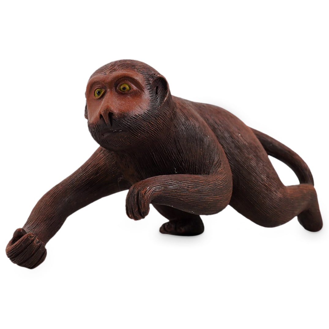 Japanese Ceramic Monkey: DESCRIPTION: Japanese ceramic model of a monkey. Unmarked. CIRCA: 20th century ORIGIN: Japanese DIMENSIONS: H: 3.75" W: 2.75" L: 7.25" CONDITION: Spots of minor residue. Unless otherwise stated, all i