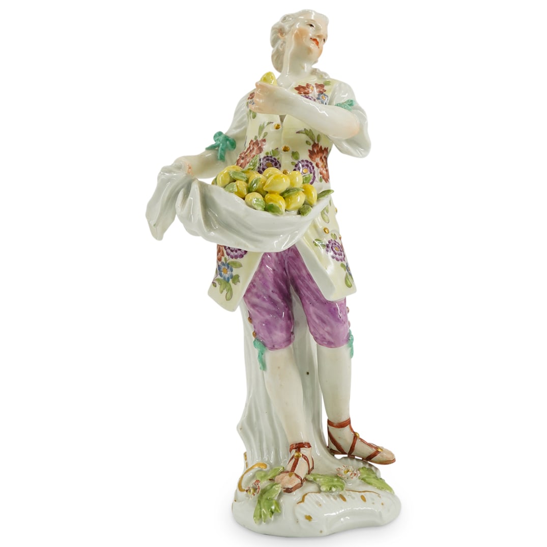 18th Cent. Meissen Porcelain Figure of a Lemon Seller: DESCRIPTION: an 18th cent. Meissen porcelain figure depicts a Lemon seller from the series of "Cris De Paris" designed by Friedrich Elias Meyer. The seller is seen holding a sack filled with freshly p