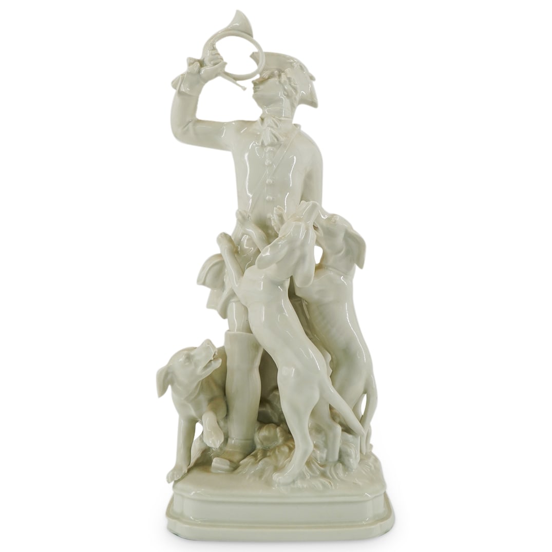 Meissen Alexander Struck (1902-1990) Hunter with Hounds: DESCRIPTION: A Meissen porcelain group designed by Alexander Struck depicts a hunter blowing a horn surrounded by his hounds, completed in a gloss glaze finish. Impressed with cross sword mark #Q237 a