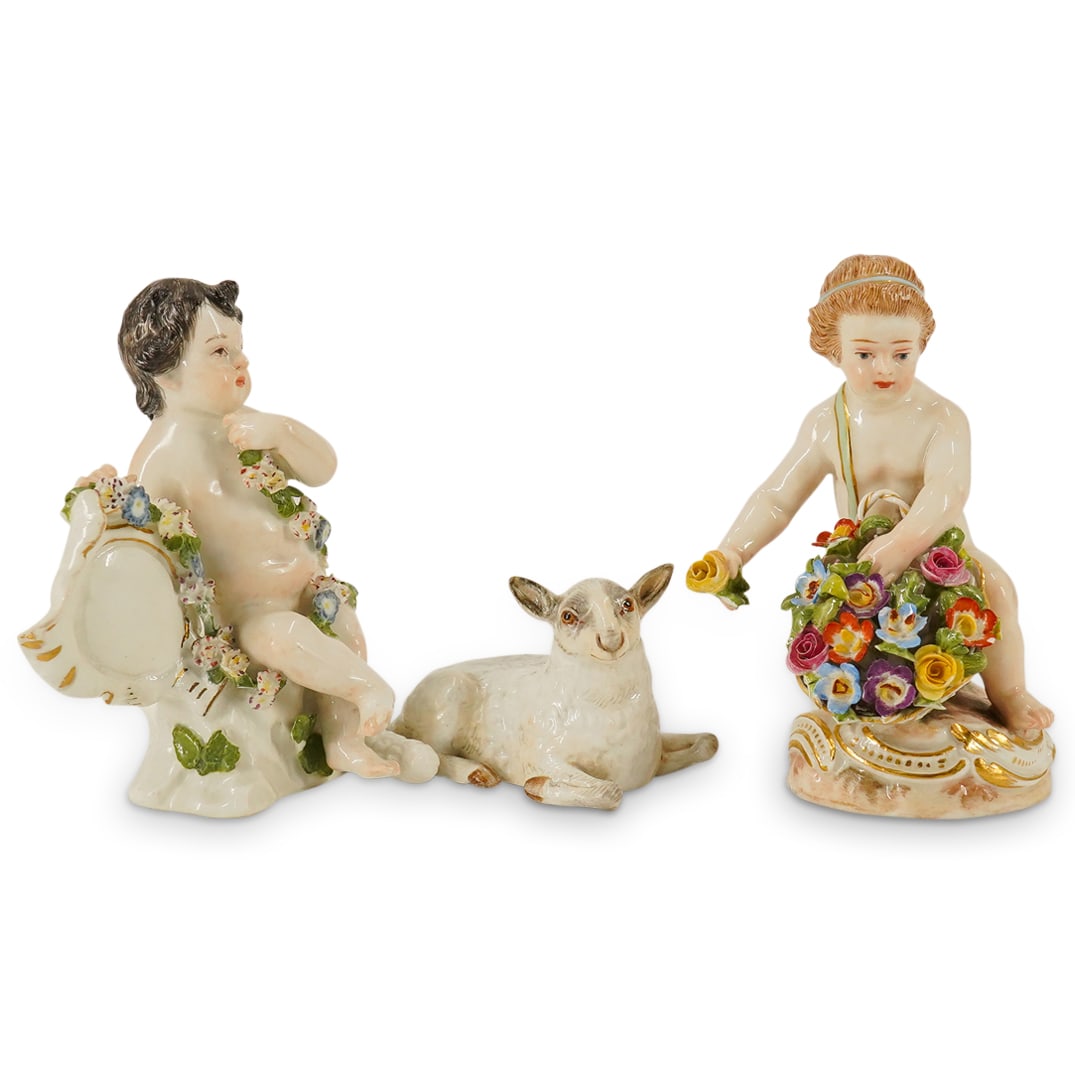 (3 Pc) Antique Meissen Porcelain Figurines: DESCRIPTION: (3 Pc) Antique Meissen Porcelain Figurines Grouping. Includes: a pair (2) of seated nude cherub figurines, surrounded by garlands of flowers, and one (1) Meissen "Sheep lying down" figuri