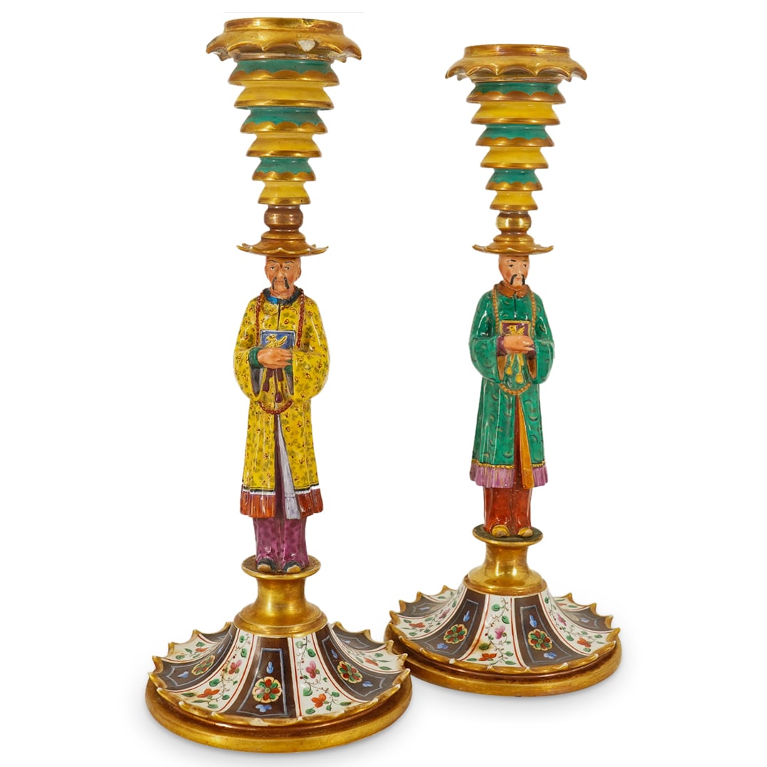 Pair of Attrib. Jacob Petit Porcelain Chinoiserie Candlesticks: DESCRIPTION: Pair of Attrib. Jacob Petit Porcelain Chinoiserie polychrome and gilt Candlesticks. Each candle stick decorated with a regal figure a the stem, standing atop a crown pointed base with flo