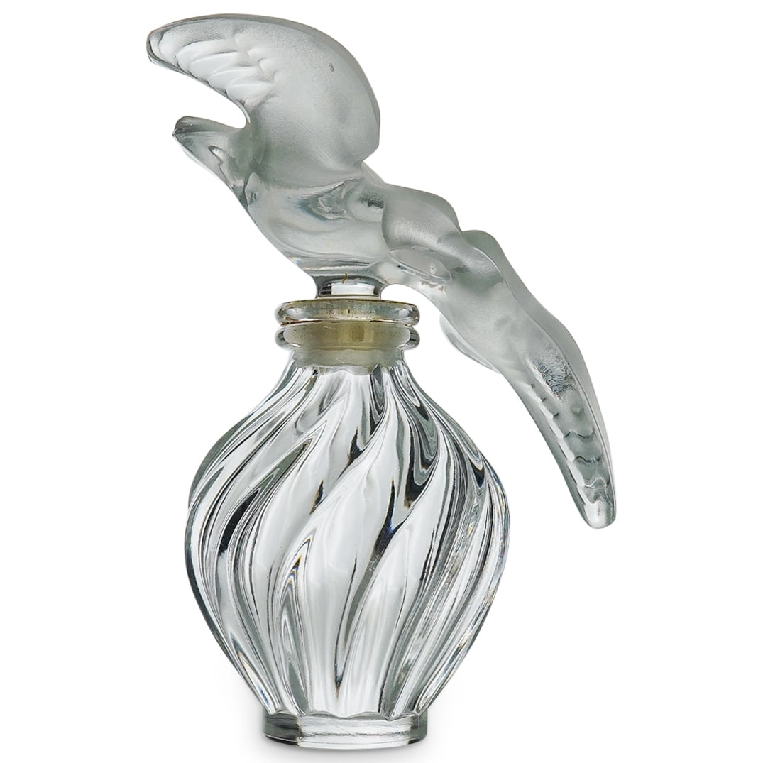 Lalique Nina Ricci L'Air Du Temps Perfume Bottle: DESCRIPTION: A Lalique glass perfume bottle for Nina Ricci "L'Air du Temps" perfume with characteristic large stopper depicting a pair of kissing doves. Marked "Lalique Nina Ricci" on the underside. C