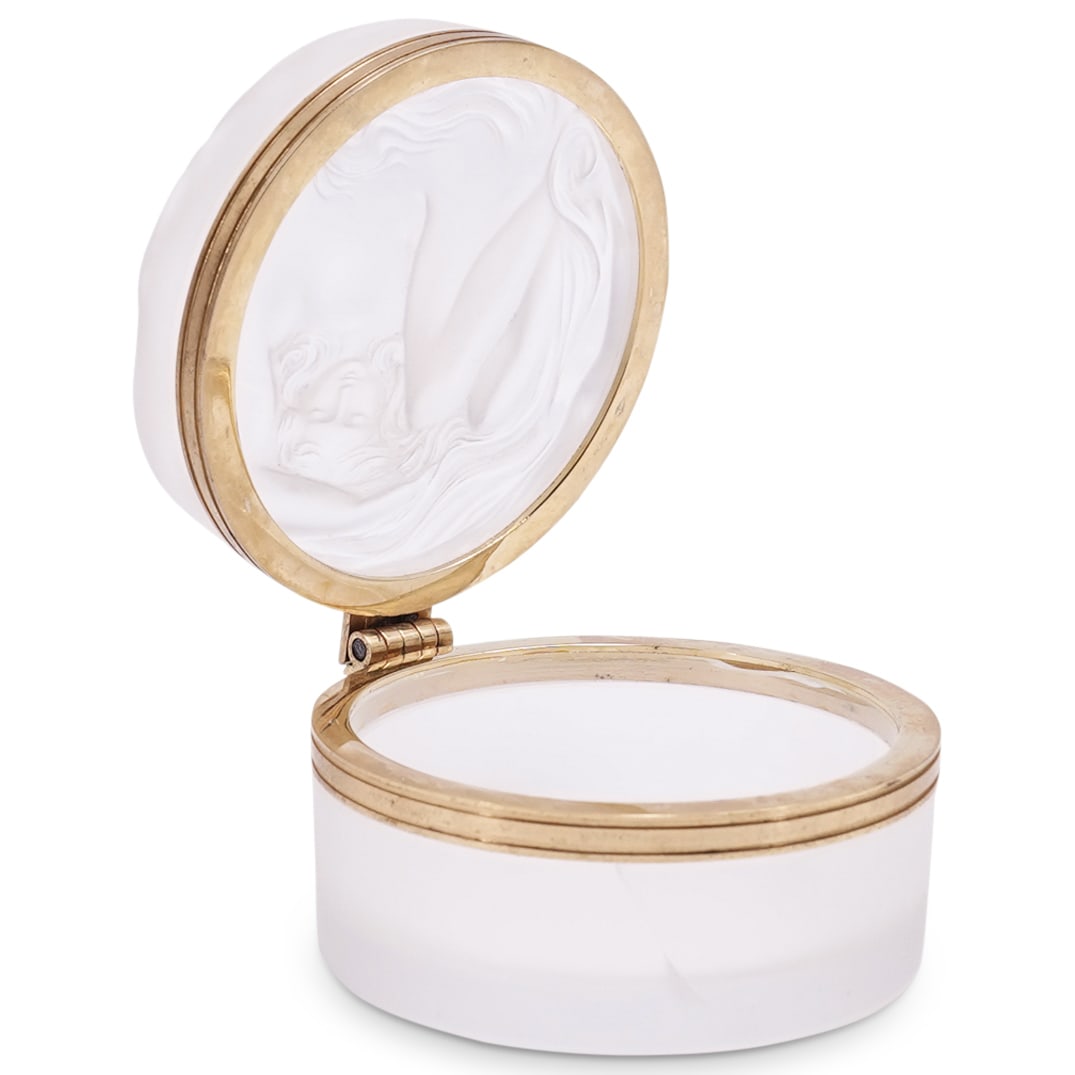 Lalique "Daphne" Crystal Box: DESCRIPTION: Lalique "Daphne" clear and frosted colorless crystal box, possibly a powder or vanity box, featuring metal fittings and depicting a nude woman. Marked on underside. CIRCA: Mid 20th centur