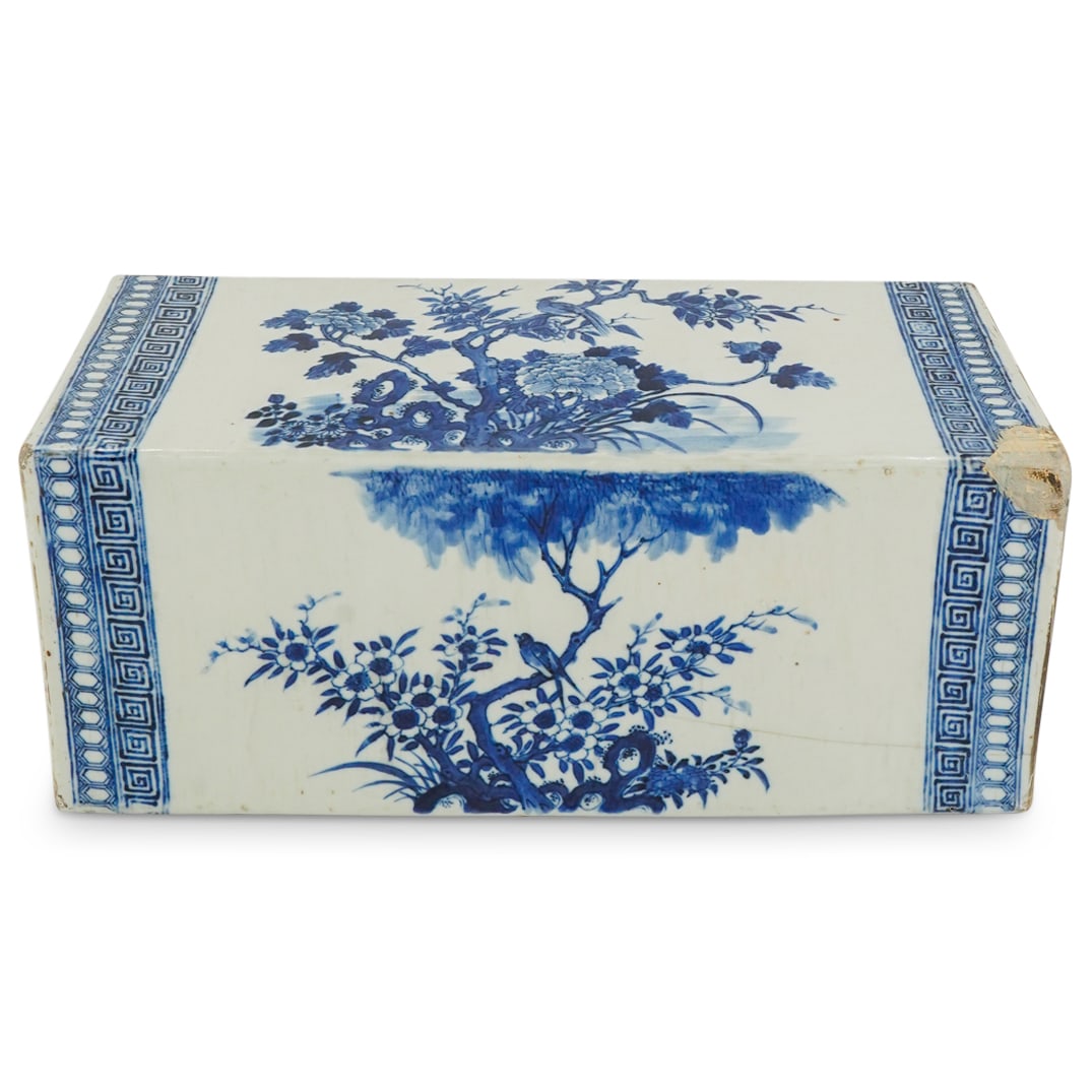 Chinese Blue & White Porcelain Pillow: DESCRIPTION: Chinese blue & white porcelain pillow decorated with flowers, foliage, birds and bats, and with one side slanting. CIRCA: 19th - 20th century ORIGIN: Chinese DIMENSIONS: H: 6" W: 7" L: 15