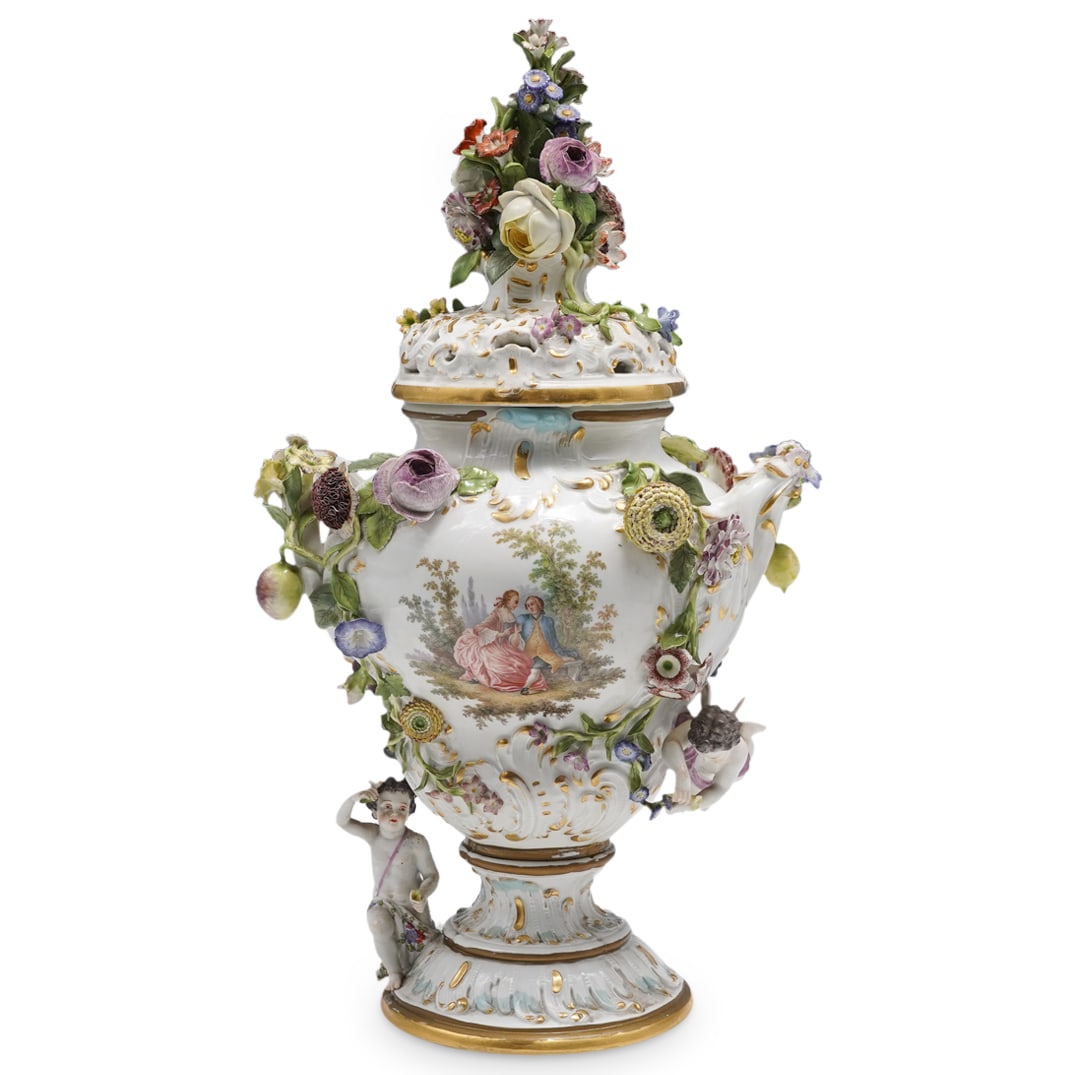 Antique Meissen Porcelain Floral & Foliage Lidded Urn: DESCRIPTION: Meissen porcelain urn featuring a pierced lid and polychrome floral and foliage designs in high relief throughout. Piece is decorated with putto designs, embellished with hand-painted flo