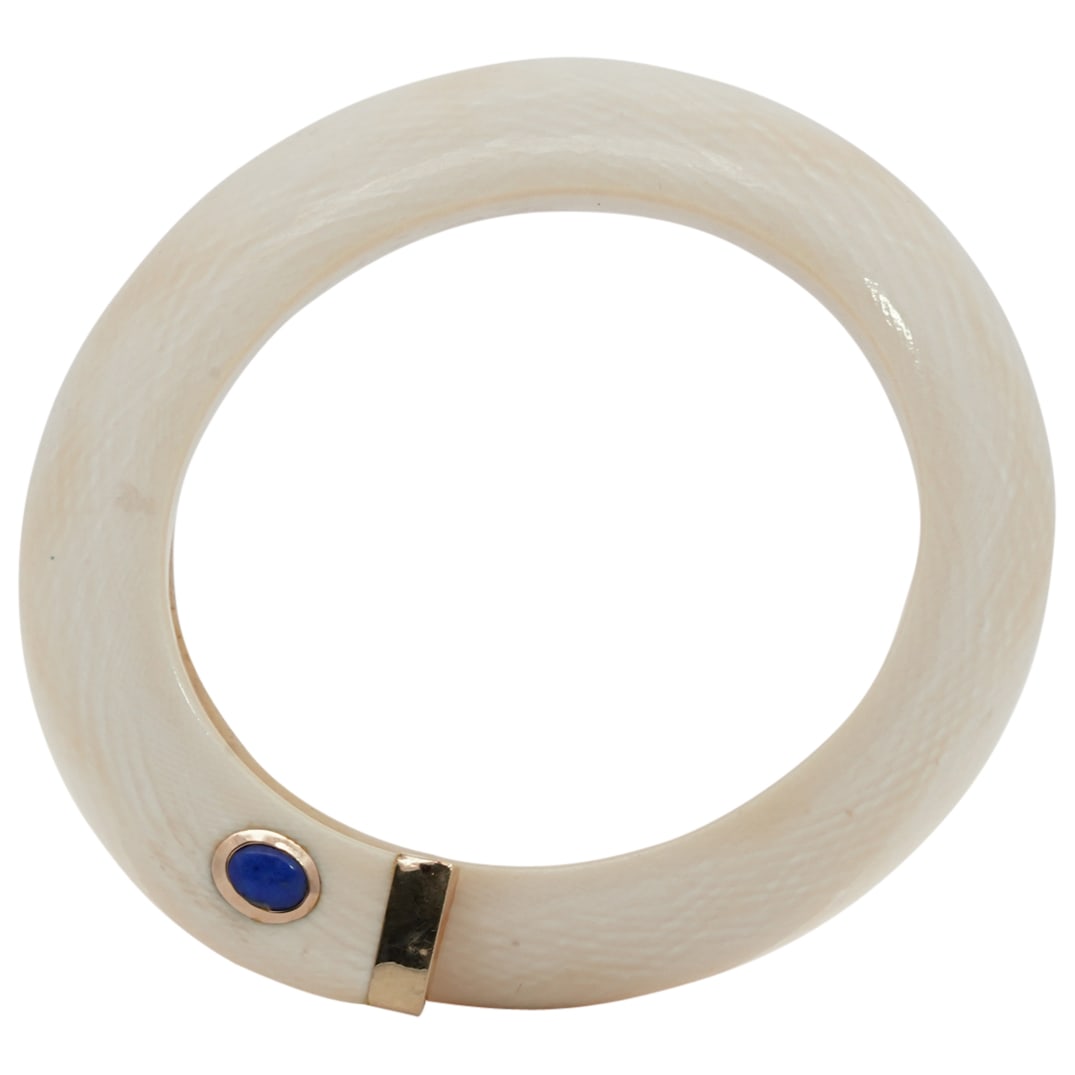 Designer 14K Yellow Gold & Bone Bangle Cuff: DESCRIPTION: Designer 14k Yellow gold mounted bone carved bangle or cuff with inset lapis lazuli cabochon. Markings: (14K 585) CIRCA: Mid 20th Cent. ORIGIN: Continental DIMENSIONS: (Inner Dia: 64.3mm)