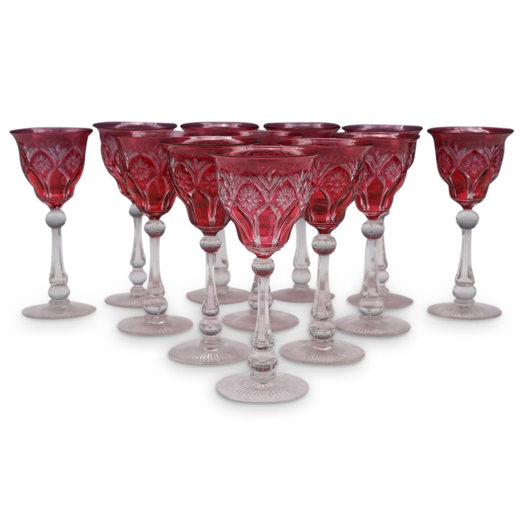 (12 Pc) French Intaglio Cut Cranberry Wine Glasses: DESCRIPTION: a set of twelve crystal wine glasses feature in clear and cranberry hued foundation decorated along the bowl with ornate intaglio cut floral patterns, completed along the underbase with s
