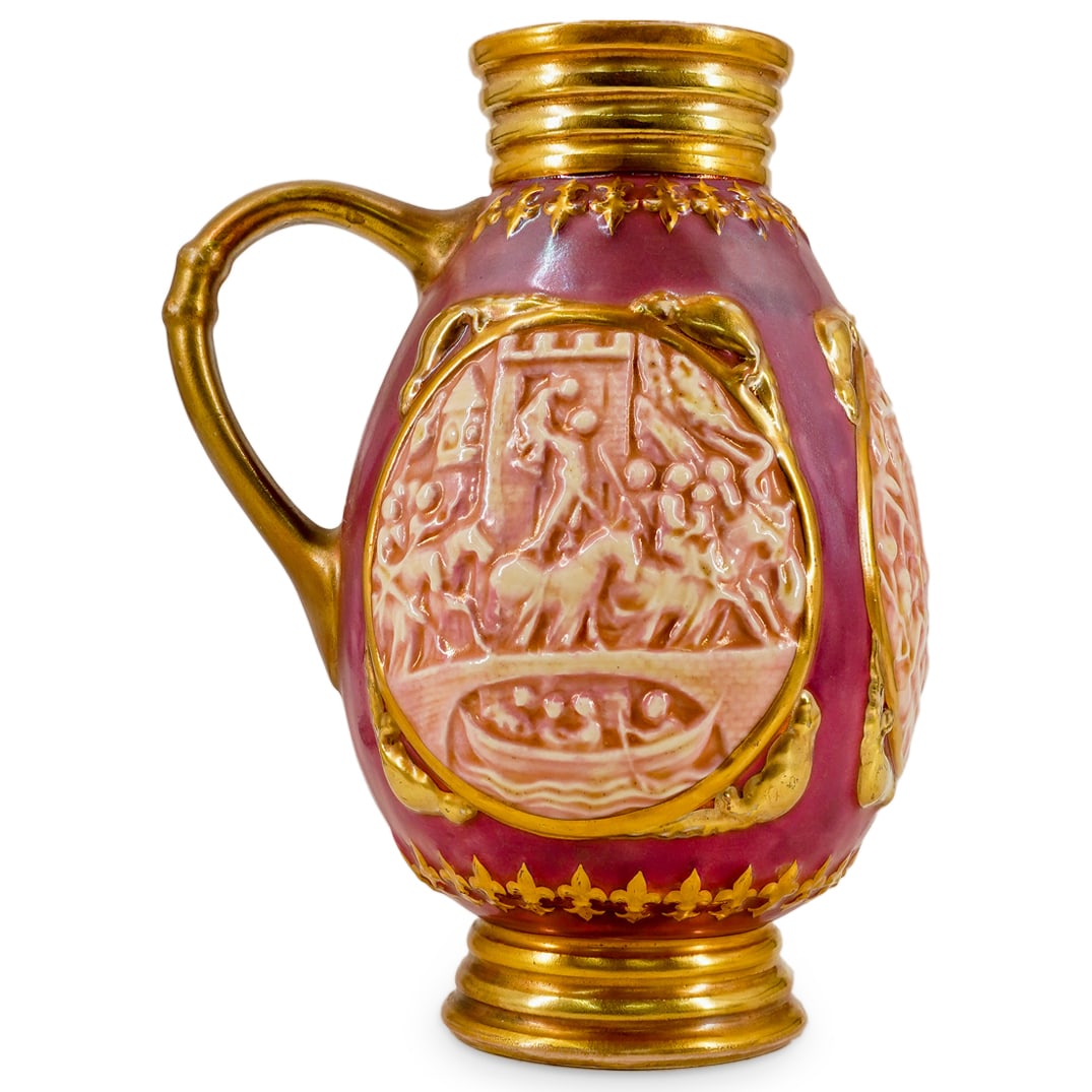 Hungarian Zsolnay Porcelain Relief Wine Vase Pitcher: DESCRIPTION: Hungarian Zsolnay Pecs porcelain wine handled pitcher, decorated with figurative scenes in semi relief, depicting figures and castles. Finished with a mauve luster patina and gilt overall