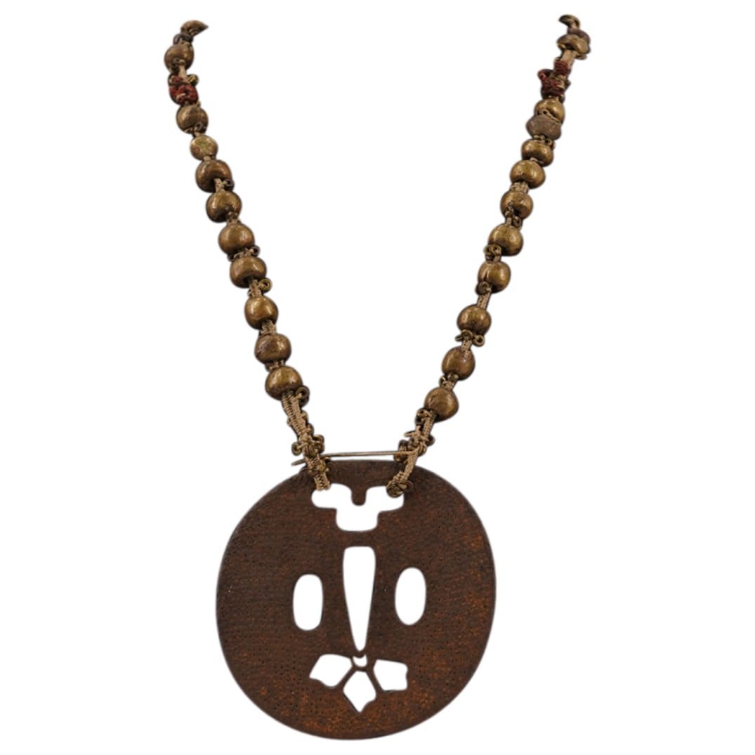 Antique Rare Meiji Japanese Cast Iron Tsuba Samurai Necklace: DESCRIPTION: Antique rare Meiji Japanese cast iron Tsuba Samurai widow necklace, with beaded chain. A tsuba is a sword guard and part of a sword mounting. It is mounted between the sword's blade and g