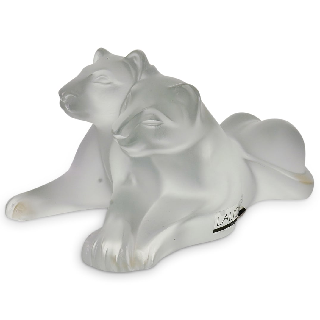 Signed Lalique France Tambwe Lion Cubs Crystal Figurine: DESCRIPTION: Lalique France Tambwe Lion Cubs Crystal Figurine. Signed Lalique France CIRCA: 20th Century ORIGIN: France DIMENSIONS: H: 3" W: 5" D: 3 5/8" CONDITION: Good Condition Unless otherwise sta