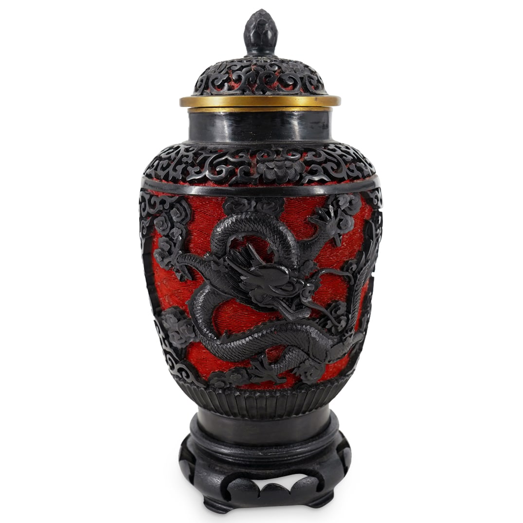 Two Tone Cinnabar Style Dragon Urn: DESCRIPTION: Two-tone Lacquered urn replicating the appearance of cinnabar, the body depicting two dragons amid cloud, the body and lid both featuring floral and foliage motifs. Completed with gilding