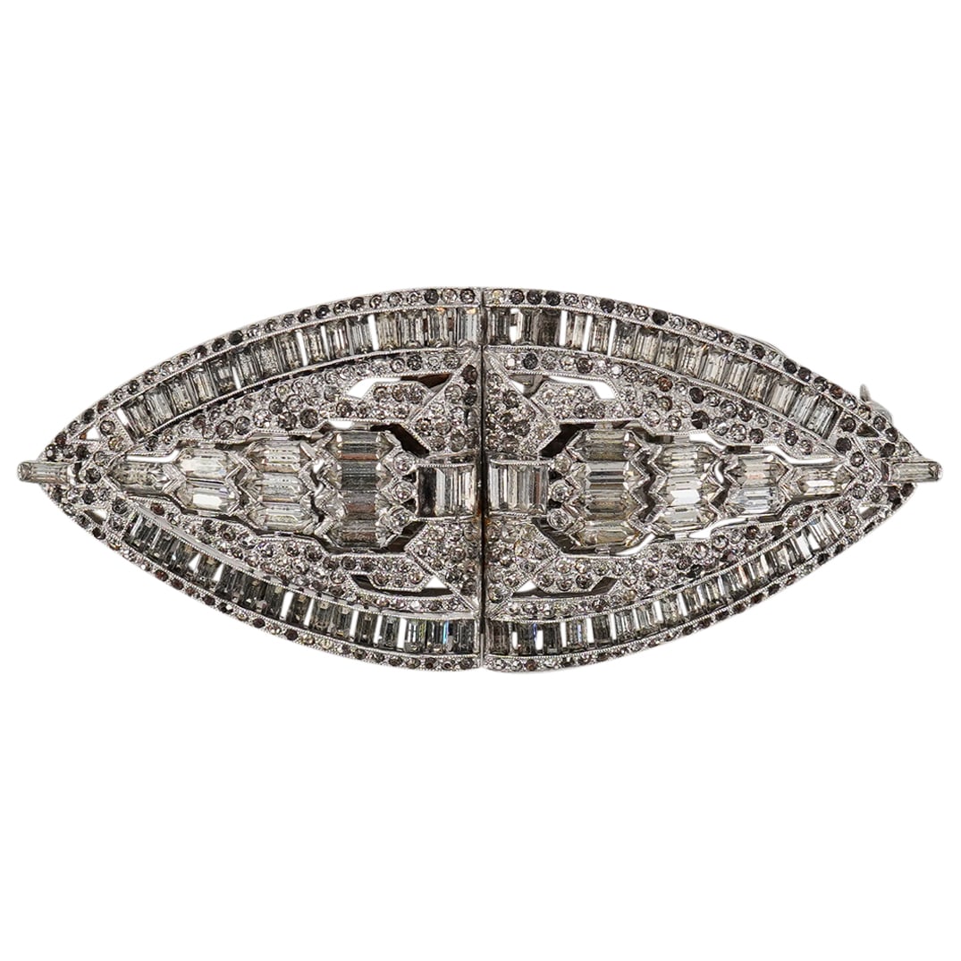 Vintage Coro Duette Art Deco Brooch: DESCRIPTION: Vintage Coro Duette Art Deco metal costume jewelry brooch decorated with inset crystals. Marked at reverse. CIRCA: Early - mid 20th century ORIGIN: - DIMENSIONS: H: 1.5" L: 3.75" CONDITIO