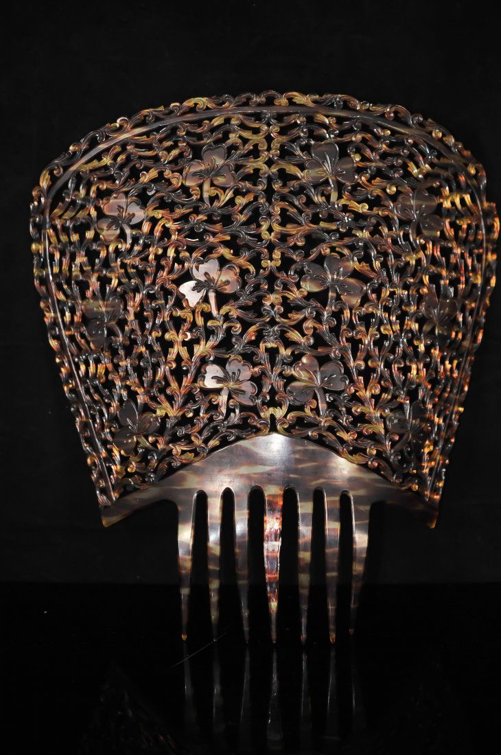 Large celluloid faux tortoise shell comb: DESCRIPTION: Large faux tortoise shell comb. Made of celluloid to look like authentic tortoise shell. Extremely large and intricate body with seven teeth. Repaired in one place. Excellent condition CI