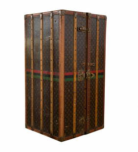 Original vintage Louis Vuitton wardrobe trunk. Com: DESCRIPTION: Large vintage Louis Vuitton wardrobe trunk. Complete interior fittings. Six drawers with the original "Louis Vuitton" stamped leather handles. (Missing two handles). Six beechwood hangers