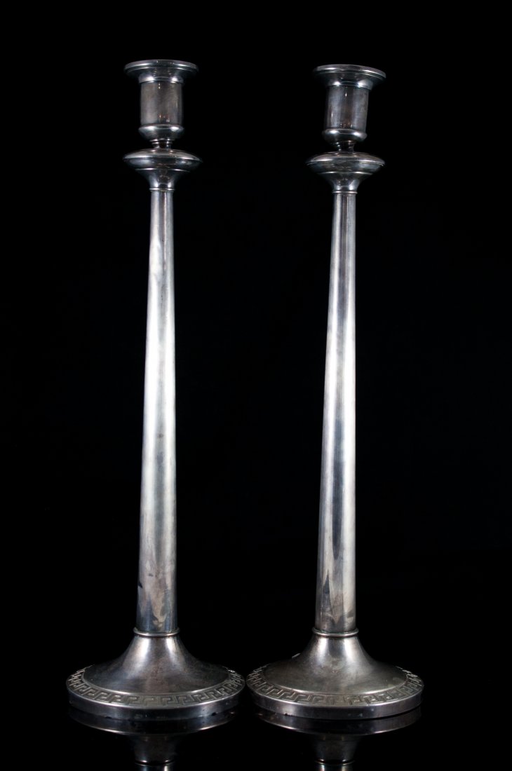 Pair of large vintage sterling Gianna Versace cand: DESCRIPTION: Pair of large vintage sterling candlesticks by "Gianni Versace". Classic Versace design engraved around the rim of it's weighted base. Long stem with mounted torcher tops. Hallmarked on r