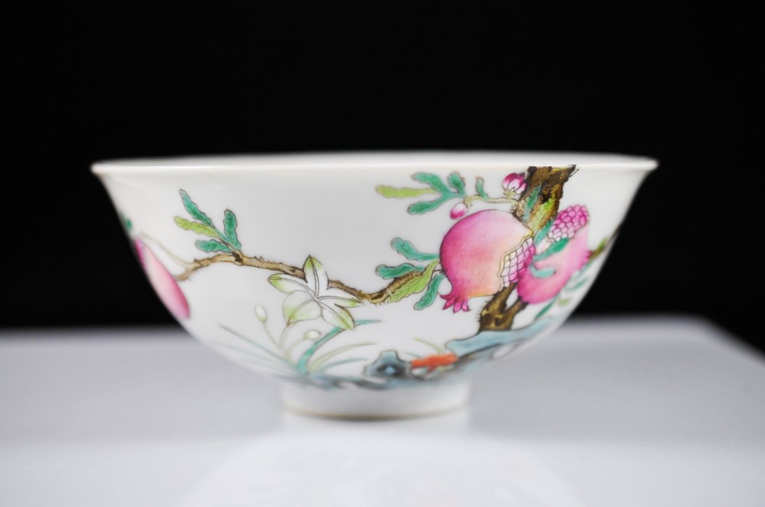 Small Chinese famille rose painted rice bowl: DESCRIPTION: Small Wucai hand painted rice bowl. Exotic fruit design with fruit bats flying above. Mint condition. Six character signature on bottom. CIRCA: 19th Century ORIGIN: China DIMENSIONS: H: 2