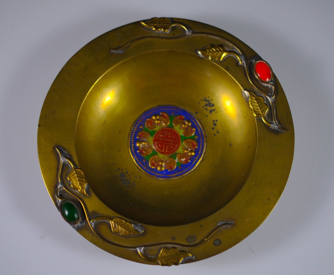 Chinese brass, enamel and multi stone candy dish: DESCRIPTION: Chinese brass and enamel candy dish. Features a double vine design around the rim with two multi colored stones set firmly in place. The center of the dish has a round seal design with a