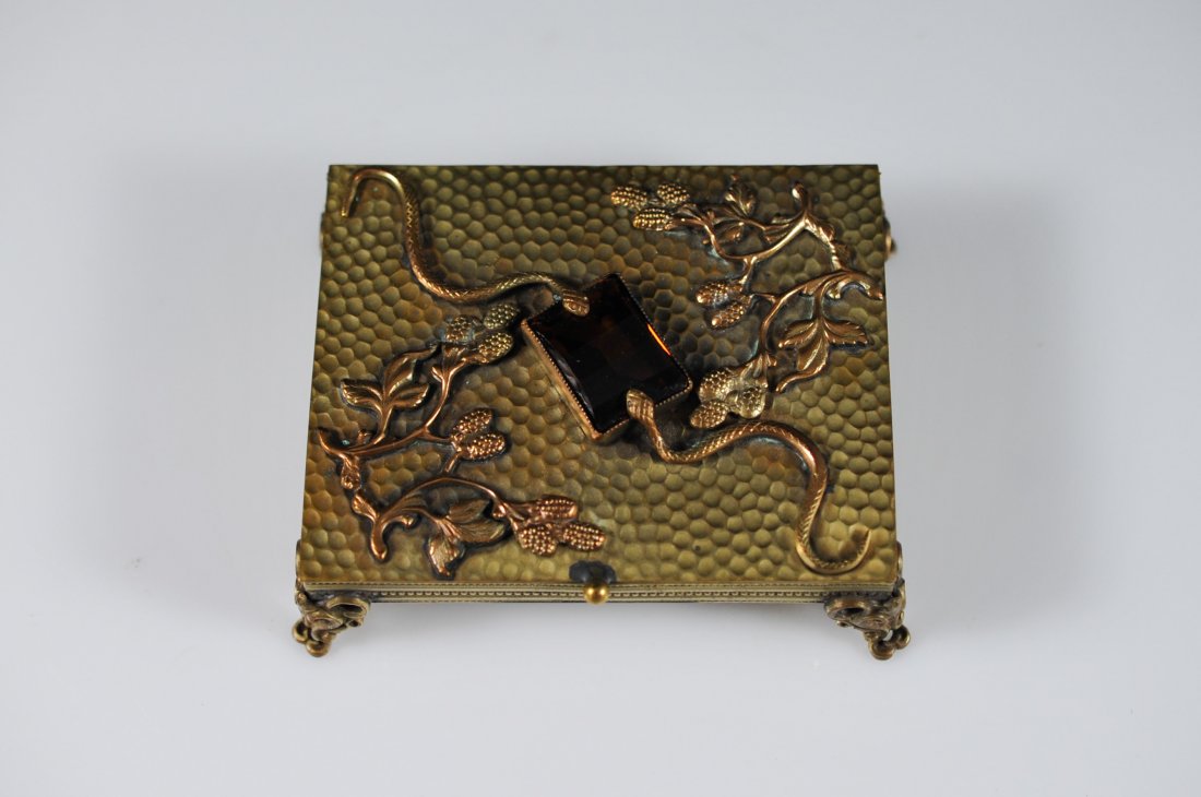 French serpent metal card case with center topaz s: DESCRIPTION: French serpent metal card case. Features a snake skin imprint design on the metal, branches with fruit and two raised serpents holding a giant topaz stone in place with their heads. Box s