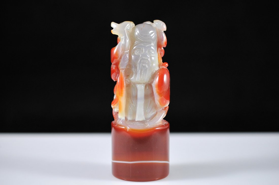 Chinese gray and blood red agate figure: DESCRIPTION: Chinese multi colored figure made of agate. Hand carved from one piece of agate. Grayish figure body with base and surrounding blood red floral design. Exquisite color throughout. Mint CI