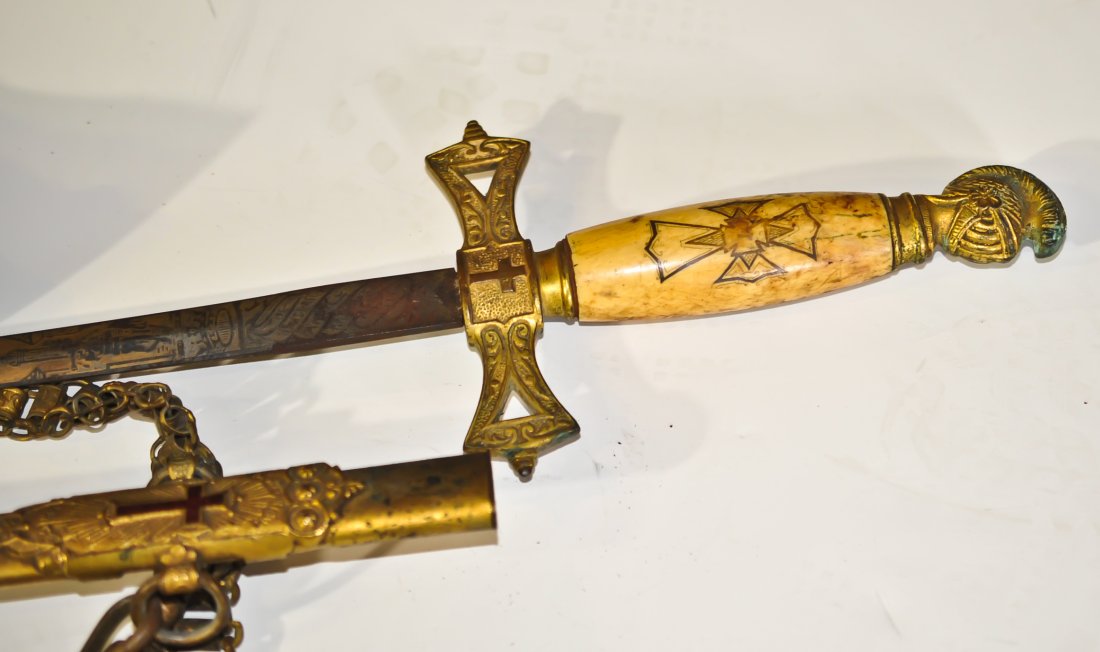 Original Henderson Ames knights templar sword: DESCRIPTION: Vintage Knights Templar sword by The Anderson Ames Co. Intricate and ornate designs on the case and blade. Ivory composite handle. Features a red enamel cross near the base of the scabbar