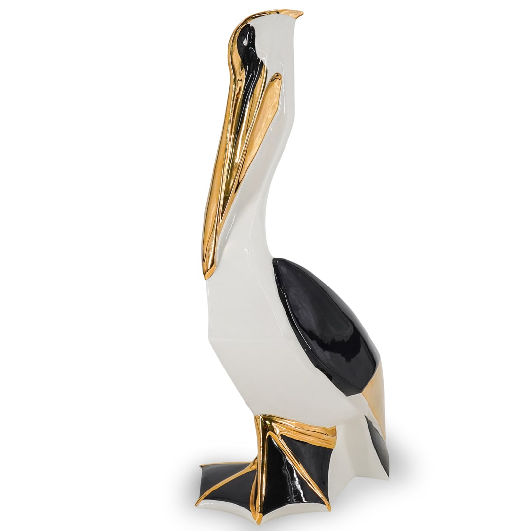 Italian Gilt Porcelain Pelican Statue: DESCRIPTION: Italian porcelain pelican statue with streamline design and parcel gilt trims. CIRCA: 20th Cent. ORIGIN: Italy DIMENSIONS: H: 19.5" x Dia: 10" CONDITION: Great overall condition Unless ot