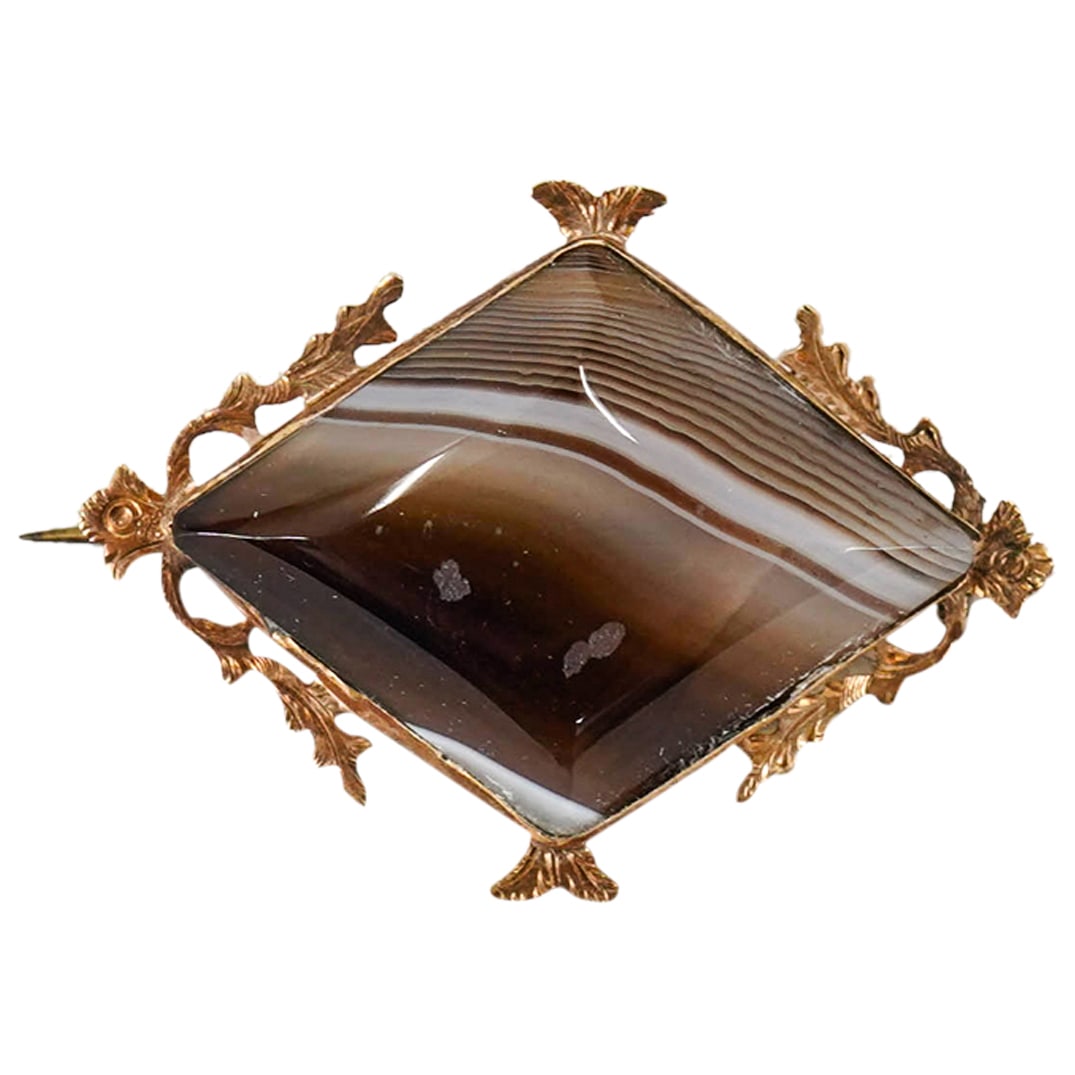 Antique Scottish Gold And Banded Agate Brooch: DESCRIPTION: Antique pin brooch crafted from a gold frame (of at least 14K) featuring a banded agate inset. Total weight: 3.44 g. / 2.21 dwt CIRCA: 19th Century ORIGIN: Scotland DIMENSIONS: H: 1" W: 0