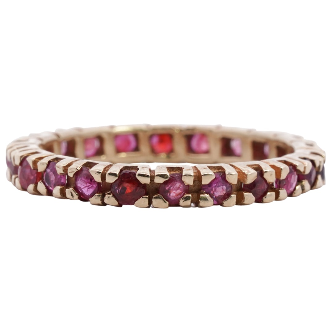 Vintage 14k Gold and Garnet Eternity Ring: DESCRIPTION: Vintage 14k Gold and Garnet Eternity Ring, inset with round cut garnets weighing .03ct each. Total Ring Weight: 2 Grams (1.3 dwt) CIRCA: Mid 20th Cent. ORIGIN: USA DIMENSIONS: Ring Size: 