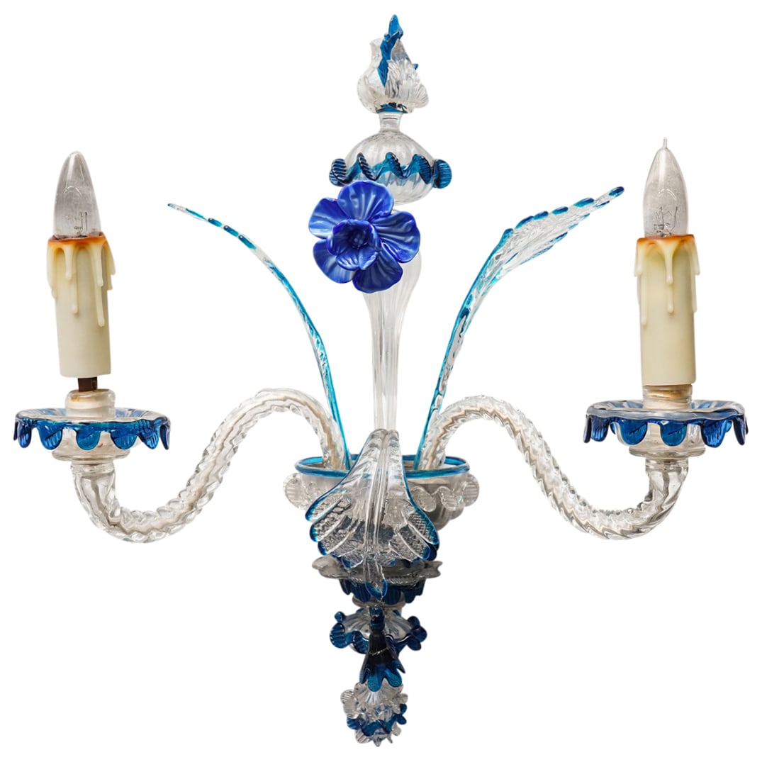 Murano Glass Chandelier: DESCRIPTION: Murano glass chandelier comprised of colorless and blue colored glass forming floral and foliage motifs. CIRCA: - ORIGIN: Italian DIMENSIONS: H: " W: " L: " CONDITION: Chip to one compone