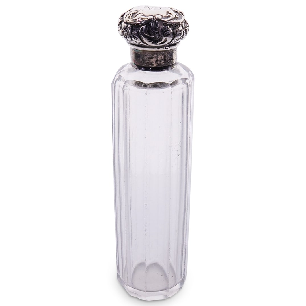 Antique English Sterling Silver Capped Perfume Bottle: DESCRIPTION: Antique faceted glass perfume bottle featuring a sterling silver cap sporting repousse flowers and foliage surrounding an "EN" monogram. Hallmarked on side of cap, maker's mark illegible.