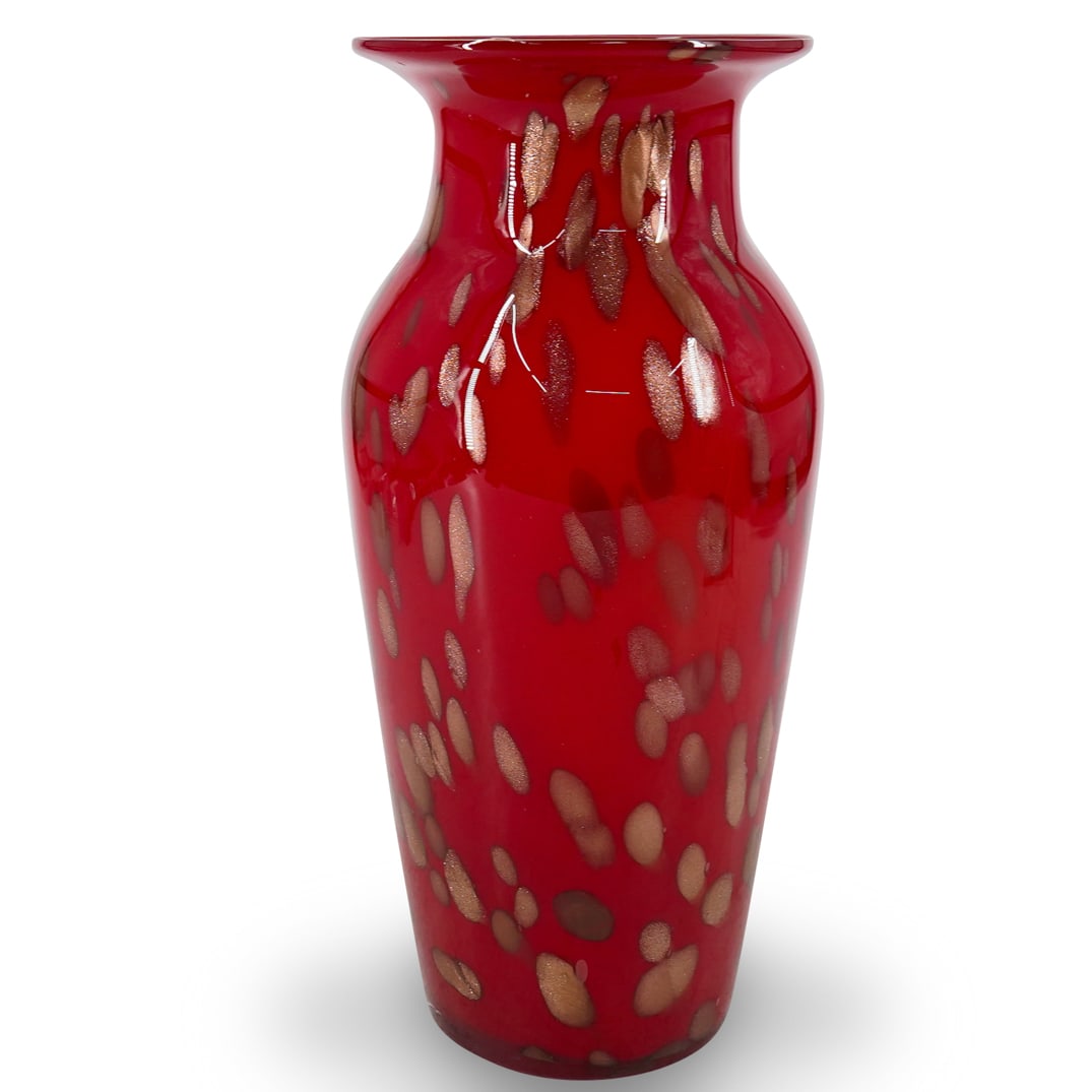 Vintage Murano Red And Goldstone Glass Vase: DESCRIPTION: Vintage Murano glass vase featuring a flared lip and shouldered form crafted in red and sporting goldstone accenting throughout. CIRCA: Mid-20th Century ORIGIN: Italy DIMENSIONS: H: 11.75