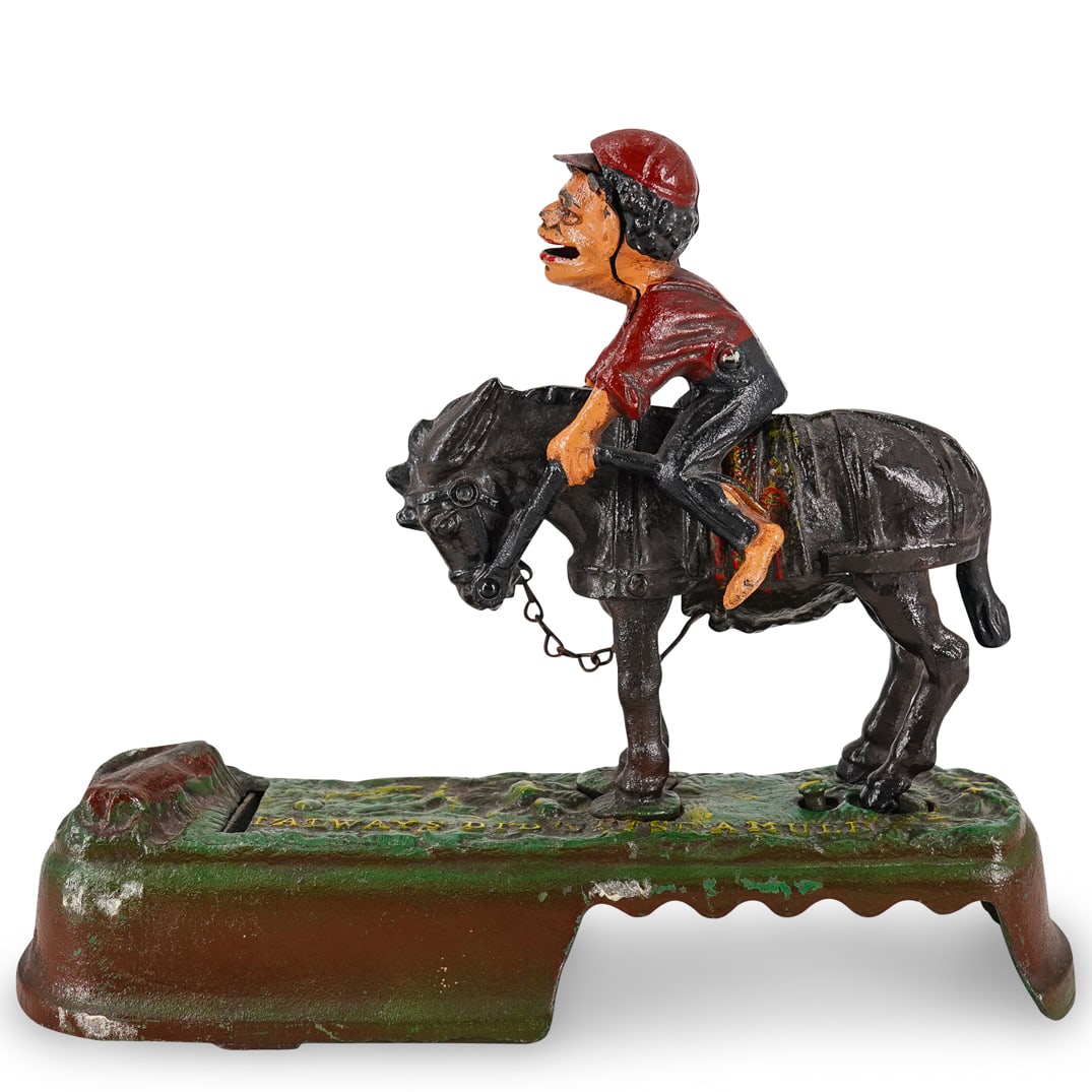 "I Always Did 'Spise A Mule" Cast Iron Coin Bank: DESCRIPTION: Book of Knowledge cast iron coin bank depicting a mule and rider. Marked on base with "I always did 'spise a mule". Marked on underside with "Reproduced from original in the collection of