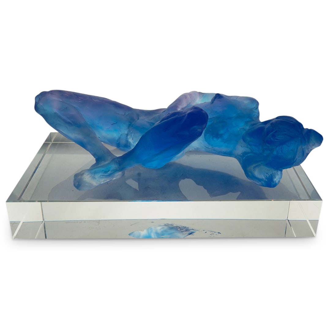 Daum Pate-Da-Verre Female Nude Sculpture: DESCRIPTION: Daum Pate-De-Verre female nude sculpture on rectangular clear base. Created with a translucent ultramarine blue hued Pate-de-Verre, the sculpture depicts a nude female figure resting faci