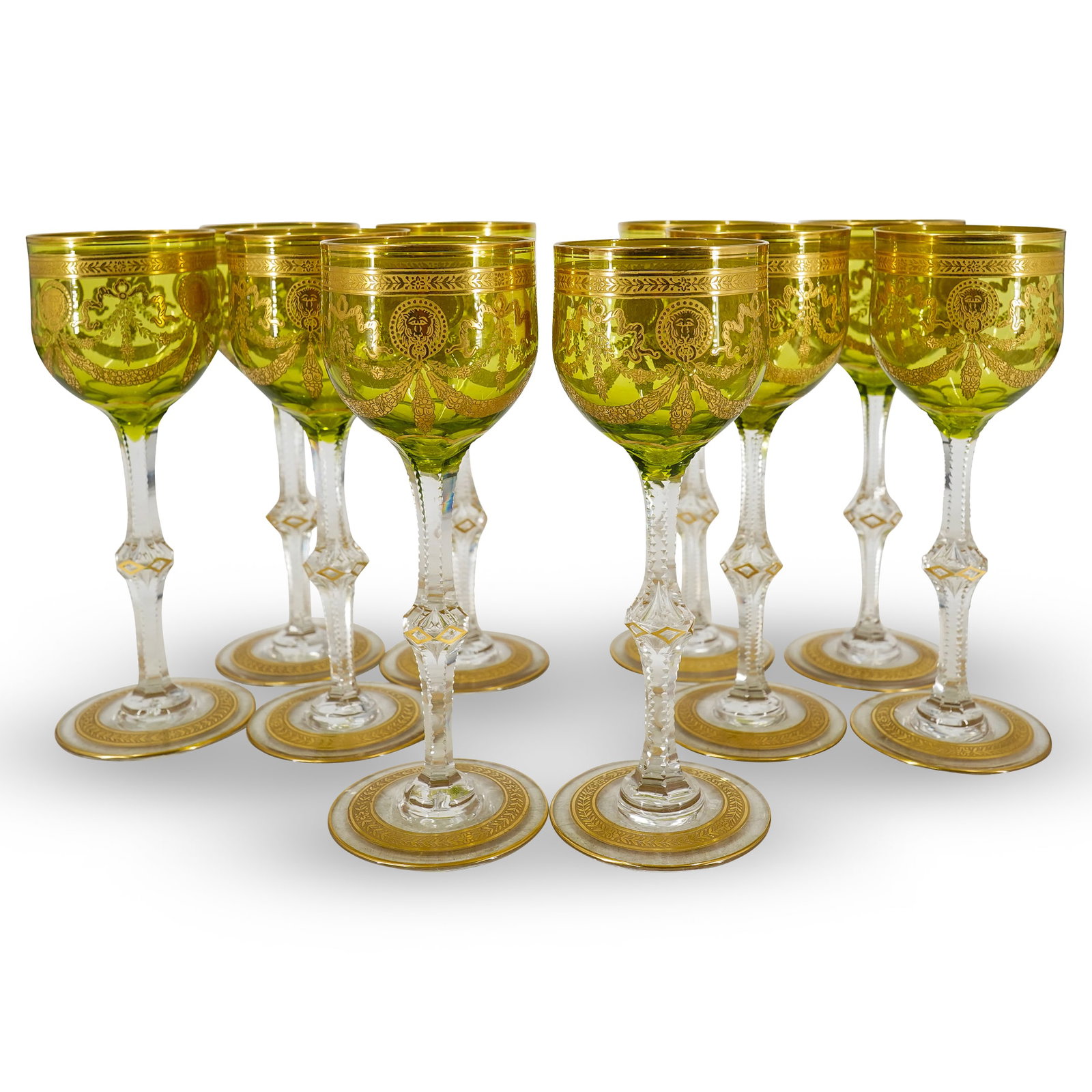 (10 Pc) Saint Louis "Congress" Crystal Wine Glasses: DESCRIPTION: 10 Saint-Louis crystal wine glasses in the "Congress" pattern, each featuring chartreuse colored bowl and each decorated with gilt foliage motifs and lion masks. Unmarked. CIRCA: 20th cen