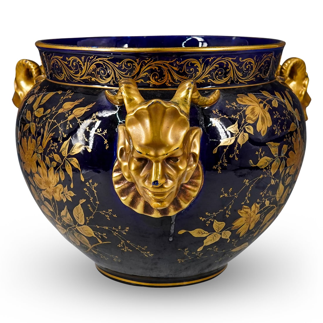 Antique Paris Porcelain Devil Horn Handled Jardiniere Vase: DESCRIPTION: Antique French Paris porcelain handled jardiniere vase in glazed cobalt blue color, with hand painted gilt floral motifs and three devil horn shaped figural handles. CIRCA: Early 20h Cent