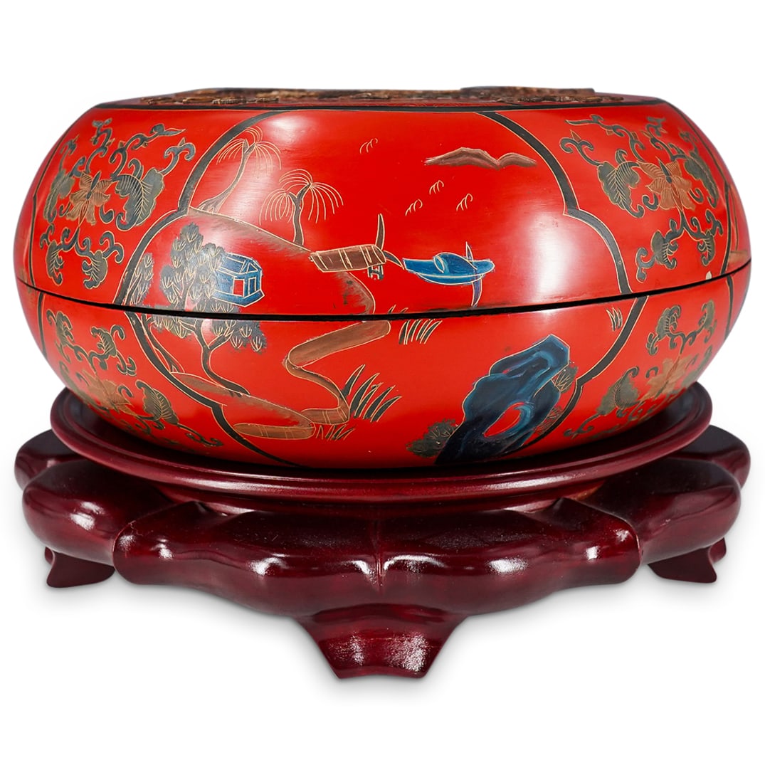 Antique Chinese Lacquered Wooden Round Box: DESCRIPTION: Antique round box coated throughout lid and base in red and black lacquer featuring rock garden and riverside village scenes around its side and sporting carved bone inlaid Buddhist treas