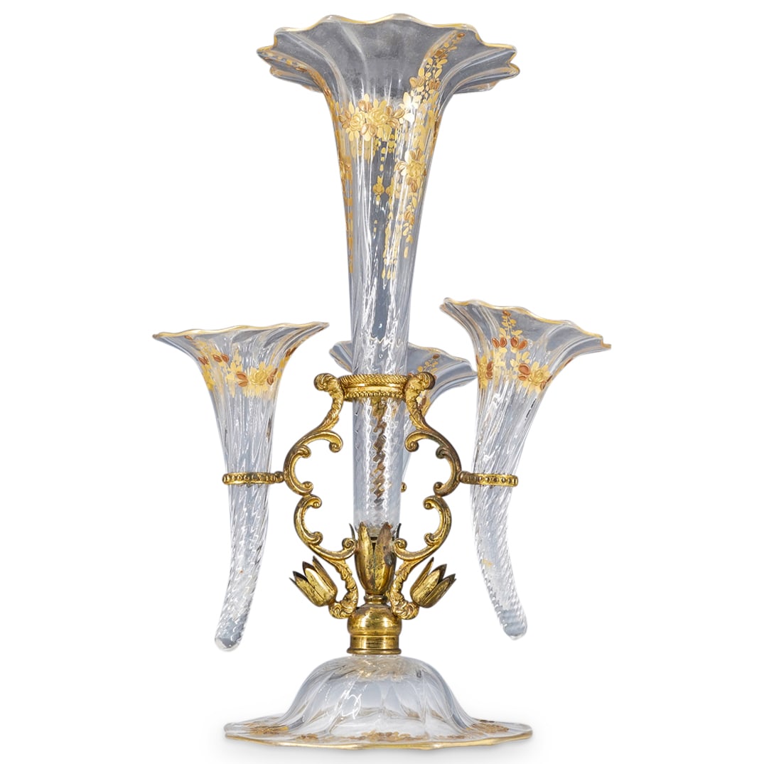 Antique Gilt Metal & Glass Epergne: DESCRIPTION: Antique epergne featuring an ornate gilt metal base with three cornucopia formed glass inserts and center raised flared insert, all completed with floral and gilt enamels. CIRCA: 19th Cen
