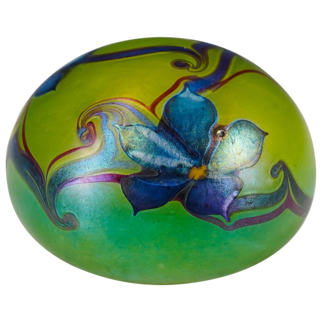 1975 Floral Green Glass Paperweight: DESCRIPTION: Vintage green glass paperweight with hand painted iridescent blue flowers, blue and purple vines. Signed artist name indistinctly and "1975" CIRCA: Late 20th cent. ORIGIN: American DIMENS