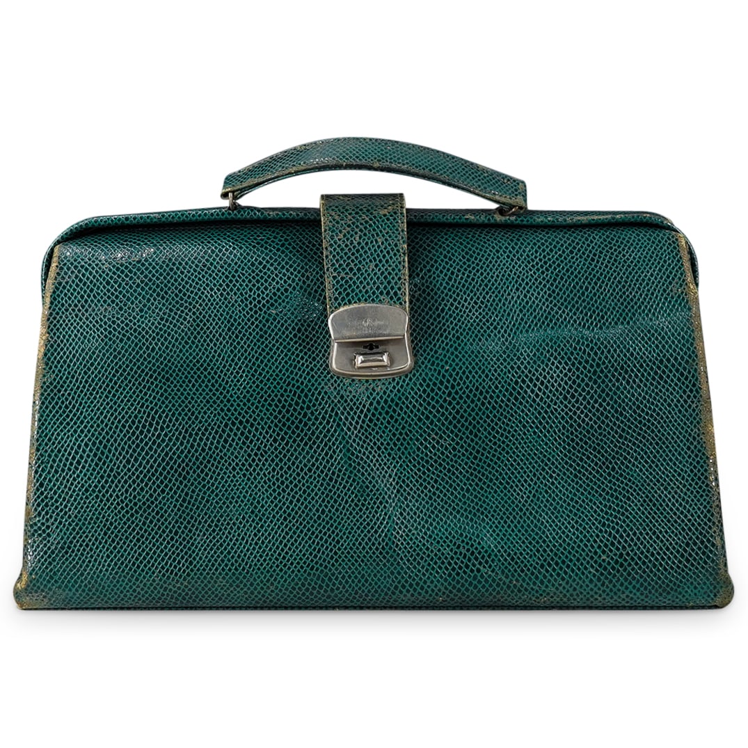 Vintage Green Reptile Doctor Bag: DESCRIPTION: Vintage green reptile skin doctor bag, features silver locking clasp and beige satin interior. CIRCA: 20th Cent. ORIGIN: Continental DIMENSIONS: H: 9.25" W: 5" L: 15" CONDITION: Exterior 
