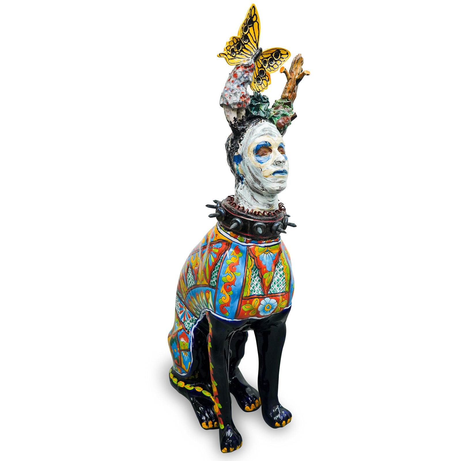 Carlos Alves (Cuban, XX) Surrealist Dog Mixed Media: DESCRIPTION: Mixed media by Carlos Alves composed of a ceramic dog body fitted with a spiked collar and human head sporting butterfly form horns and a dog face mask. Dog body features a colorful glaze