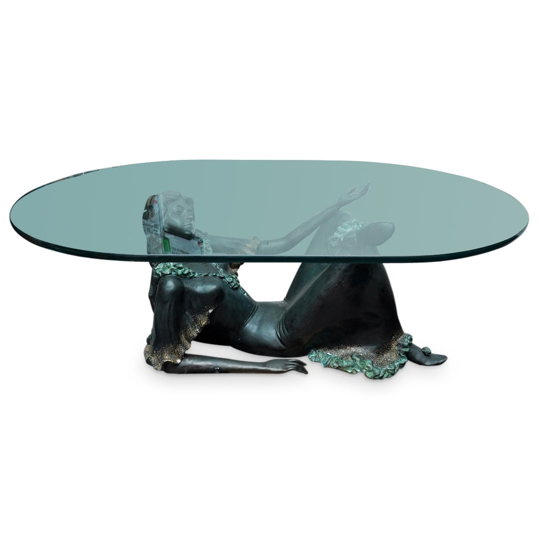 Antique French Bronze Reclining Woman Table: DESCRIPTION: Antique bronze table crafted as a woman donning a frilly-hemmed dress and reclining on her elbows while crossing her legs and supporting the thick glass table top. CIRCA: 20th Century ORI