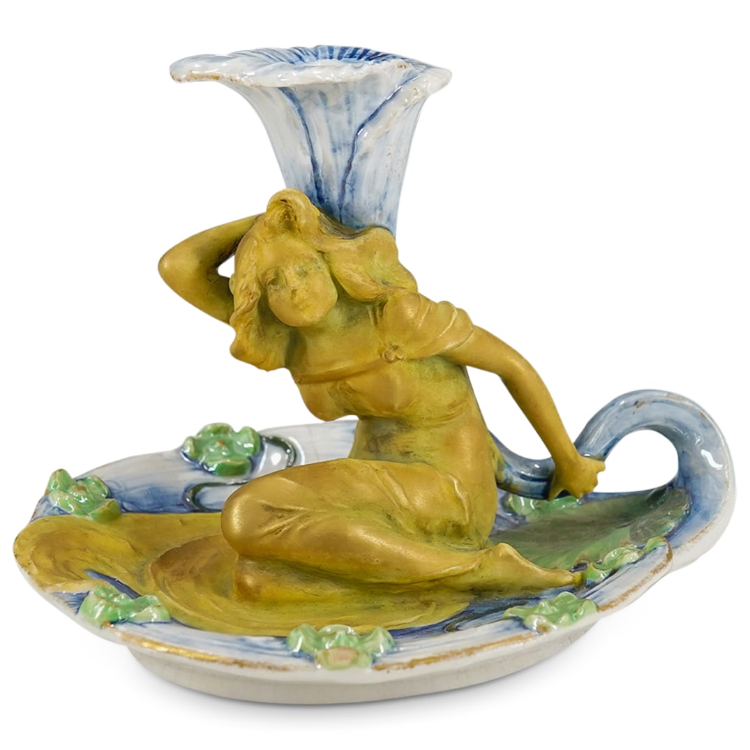 Ernst Wahliss Art Nouveau Porcelain Figural Candle Holder: DESCRIPTION: Art Nouveau candle holder by Ernst Wahliss featuring a figural candlestick proper depicting a woman in a pond among lily pads. Hallmarked on underside with Wien crown mark. CIRCA: 1897-19