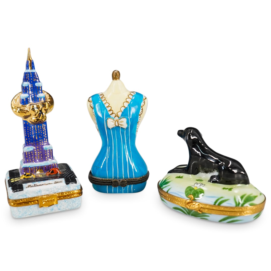 (3 Pc) Limoges Peint Mein Porcelain Pill Boxes: DESCRIPTION: Set of 3 Limoges porcelain trinket boxes, featuring Empire State Building with a gold wreath around the top, a street and two small cars beneath it, the front reads "Millennium 2000" gilt