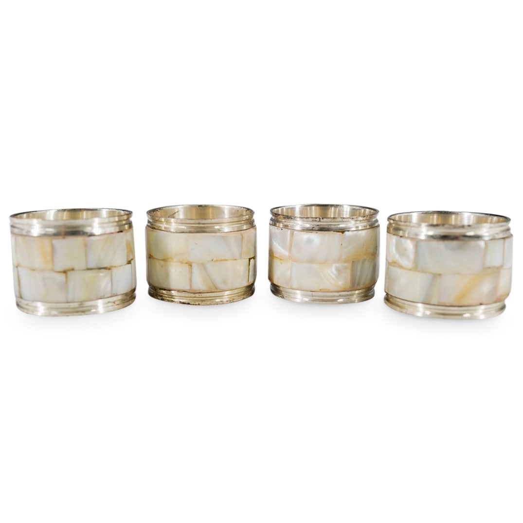 (4 Pc) Vintage Mother-Of-Pearl Napkin Ring Holders Set: DESCRIPTION: (4 Pc) Vintage Mother Of Pearl napkin ring holders set of four, with a silver tone metal mounting. CIRCA: 20th Century ORIGIN: Continental DIMENSIONS: H: 1 1/4" W: 1 1/2" CONDITION: Good