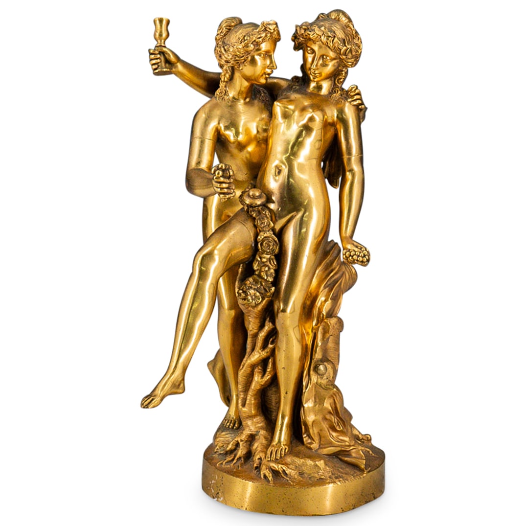 Antique Gilt Bronze Nude Women Sculpture: DESCRIPTION: Antique gilt bronze sculpture of two nude Bacchanalian women embracing, leaning on a tree stump. One holding grapes, the other holding a chalice in one hand and grapes in the other. CIRCA