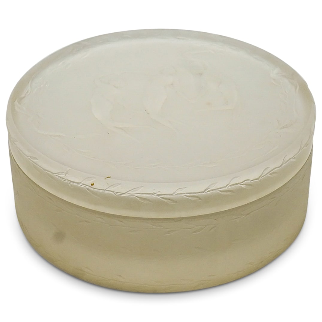 Rene Lalique 'Trois Figurines' Powder Box: DESCRIPTION: Rene Lalique 'Trois Figurines' glass powder box with circular design with the lid decorated with three dancing nude figures in semi relief. CIRCA: 1950s ORIGIN: France DIMENSIONS: H: 1 1/