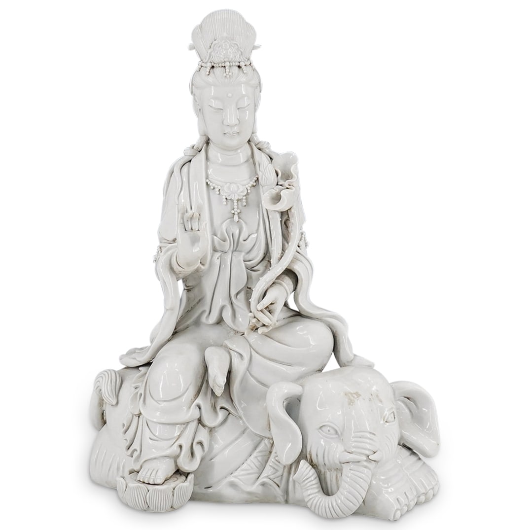 Antique Chinese Blanc De Chine Porcelain Guan Yin On Elephant: DESCRIPTION: Antique blanc-de-Chine porcelain statue depicting Guan Yin bearing a lotus while seated on an elephant, resting her foot on a lotus blossom, and making the attacking gesture with her righ