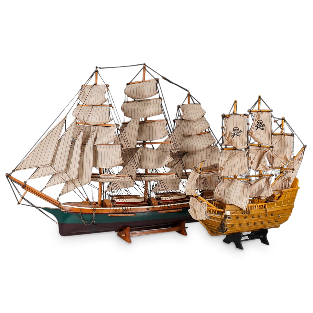 (2 Pc) Carved Wood Sailing Ship And Warship Models: DESCRIPTION: Two carved wood ship models - one a sailing ship, one a warship - each featuring textile sails and miniature block and tackle throughout. Warship bears a skull & crossbones mark on two sa