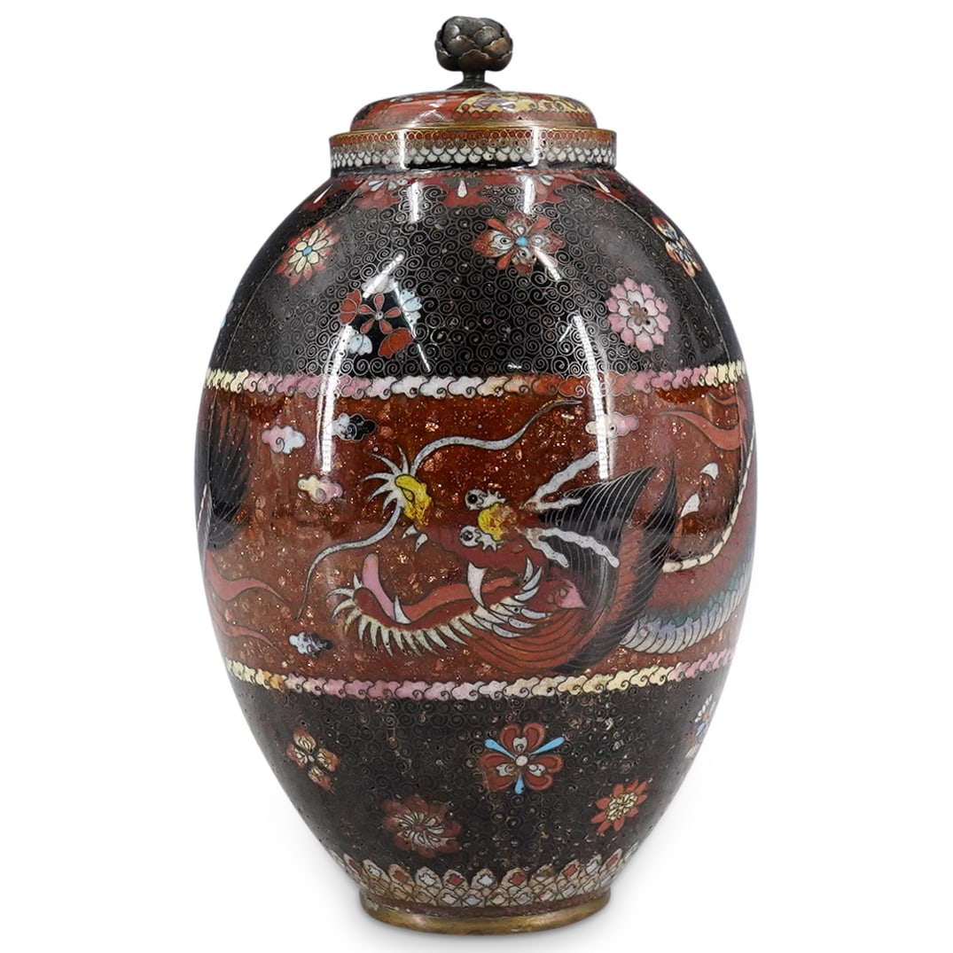 Antique Japanese Cloisonne Dragon Lidded Jar: DESCRIPTION: Antique Japanese cloisonne lidded jar, featuring goldstone middle panel, and large enamel dragon. Small enamel flowers and butterflies throughout base and top. Floral formed finial. CIRCA